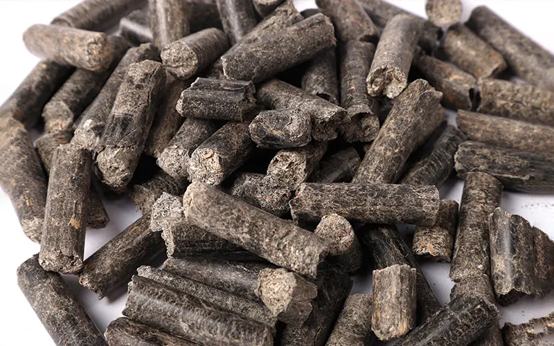 Finished dark wood sawdust biomass fuel pellets product sample